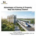 Train at station with modern buildings, trees, and road