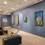 Interior view of a contemporary exhibition space displaying modern paintings and sculptures in art galleries Lahore