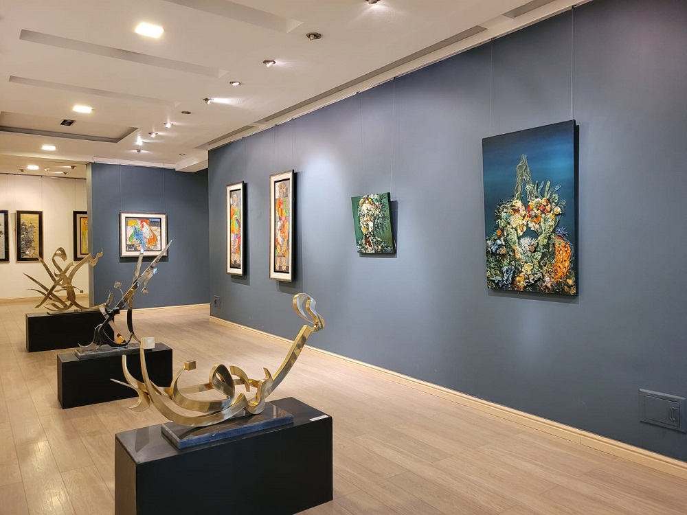 Interior view of a contemporary exhibition space displaying modern paintings and sculptures in art galleries Lahore