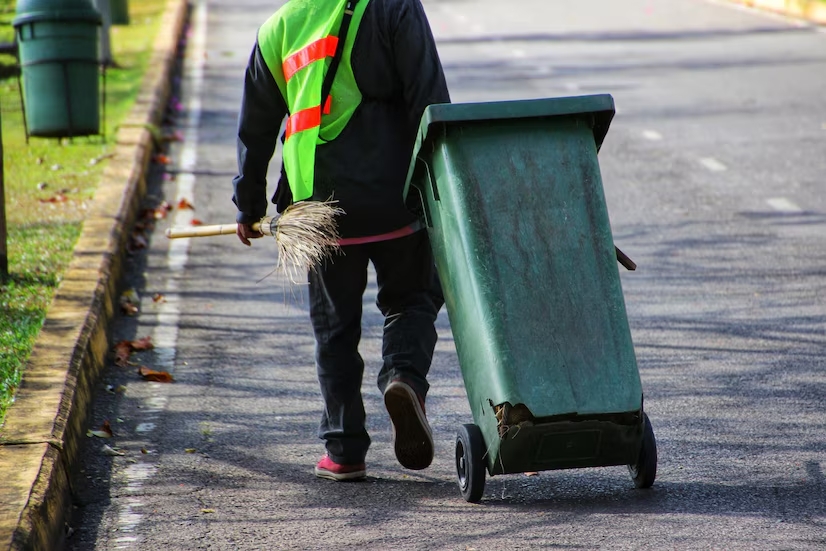 junkisremoved worker collecting trash bins during professional waste removal service